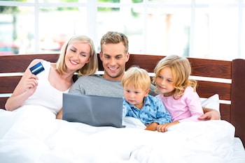 Photo of a family looking up how to buy a mattress online at Sleepworld mattress store.